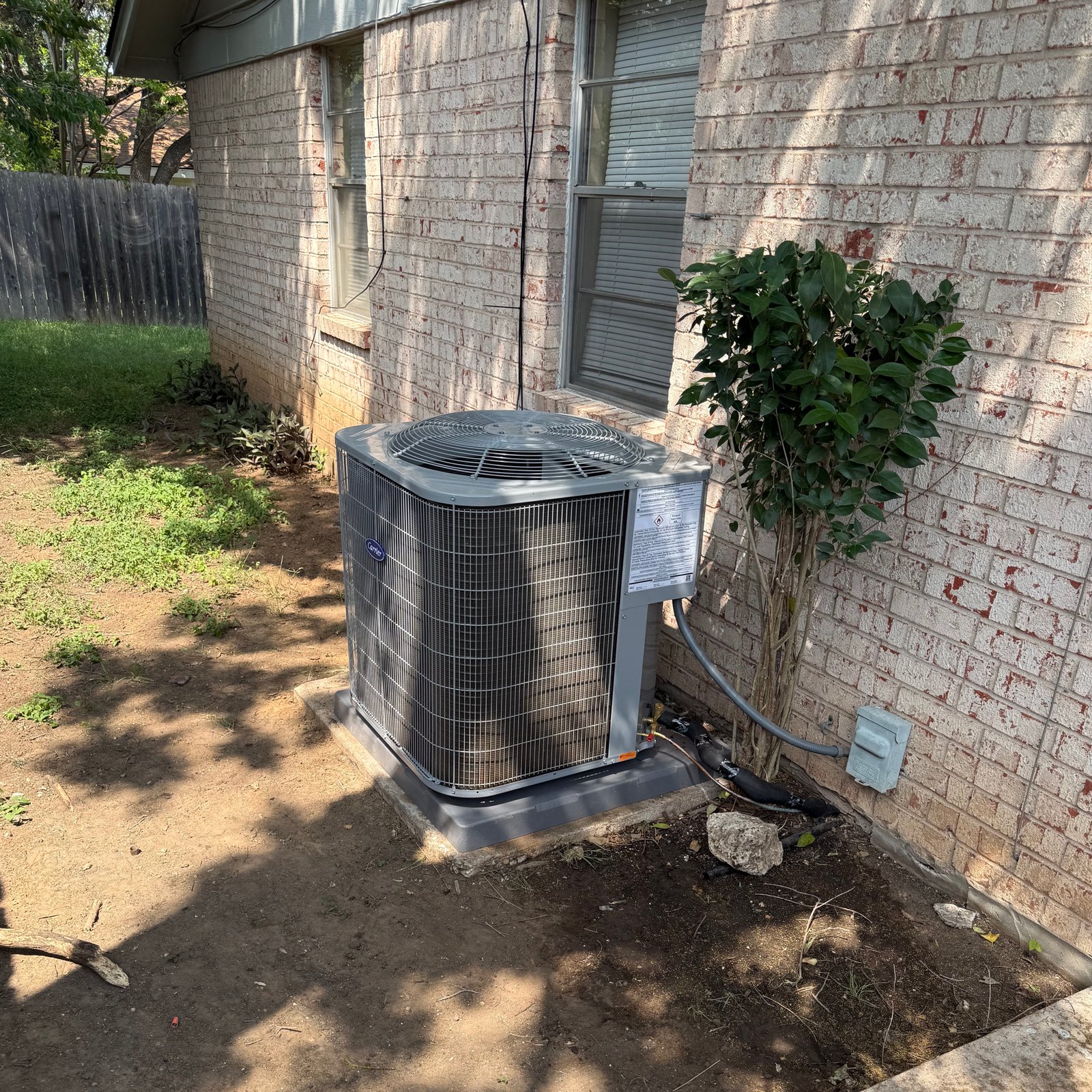 Air Dynamics of Tulsa technician diagnosing an issue during an AC Tune Up service.