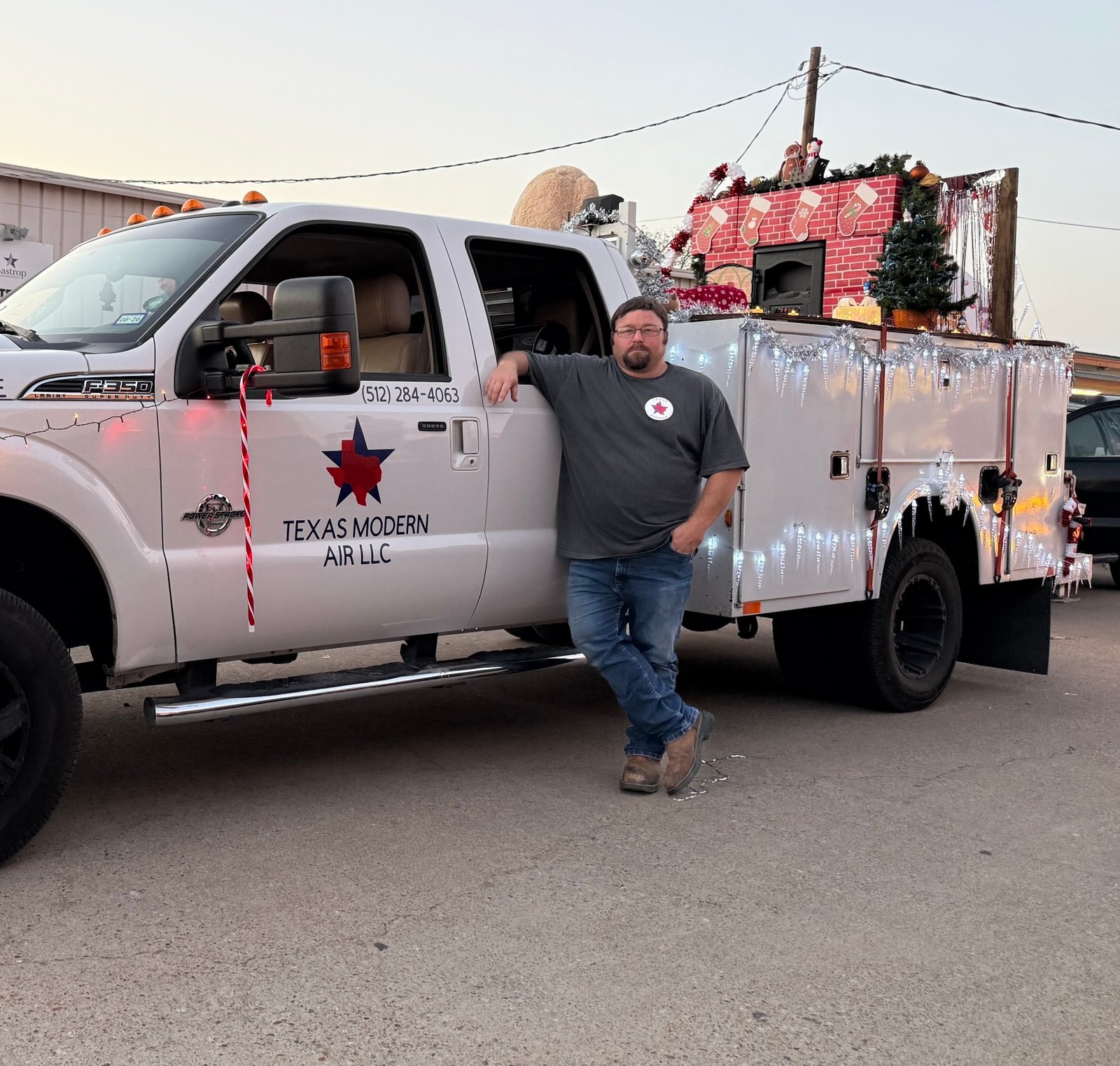 Air Dynamics of Tulsa owners Pat and Stephen, standing in front of their truck smiling.