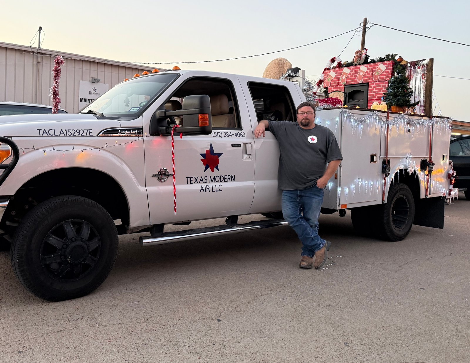 Air Dynamics of Tulsa Owner Stephen performing work on an HVAC unit in Tulsa in front of a home.
