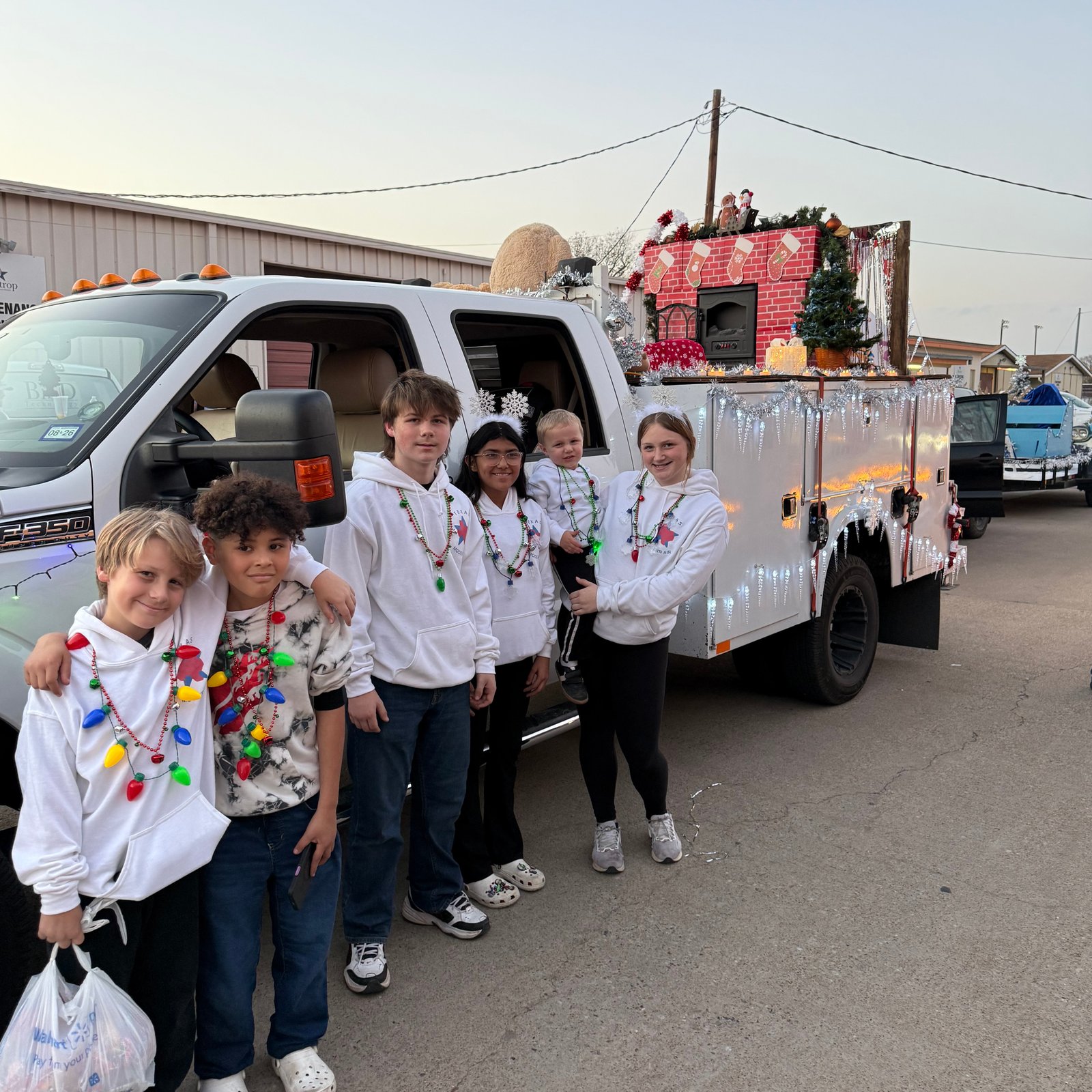 An Air Dynamics of Tulsa technician services an outdoor compressor unit beside a house in Tulsa.